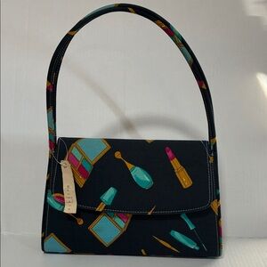 This is a Dnicole bag with a makeup-themed pattern.NWT